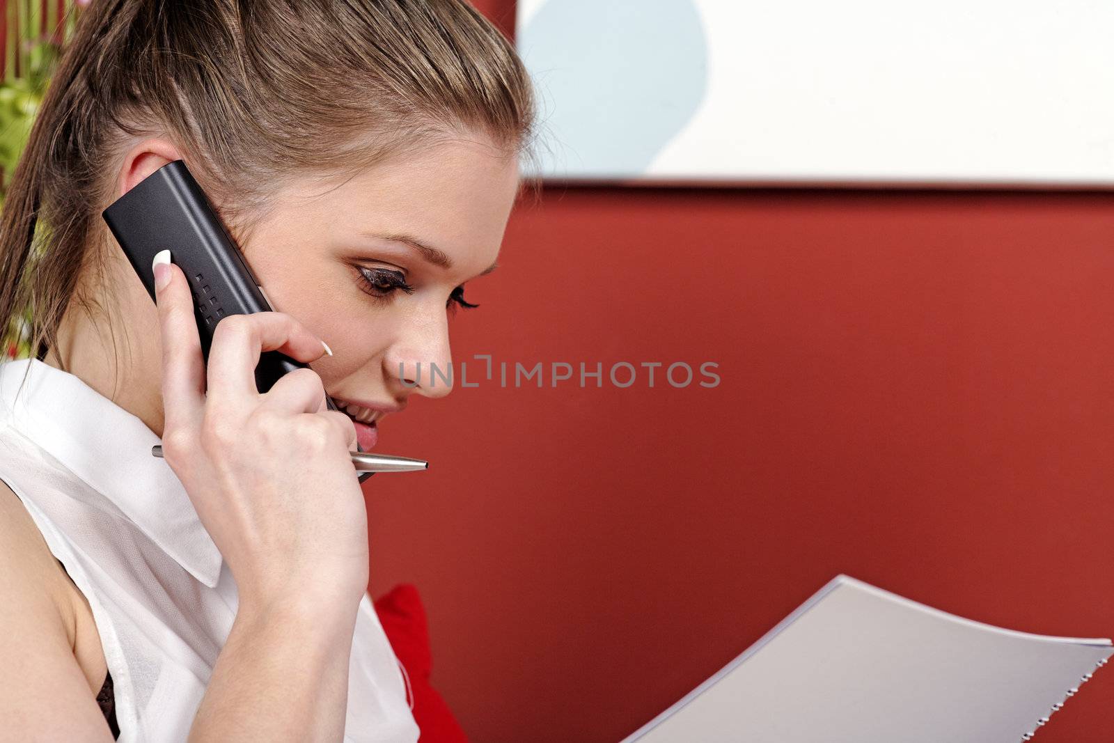 Young woman working from home reading documents