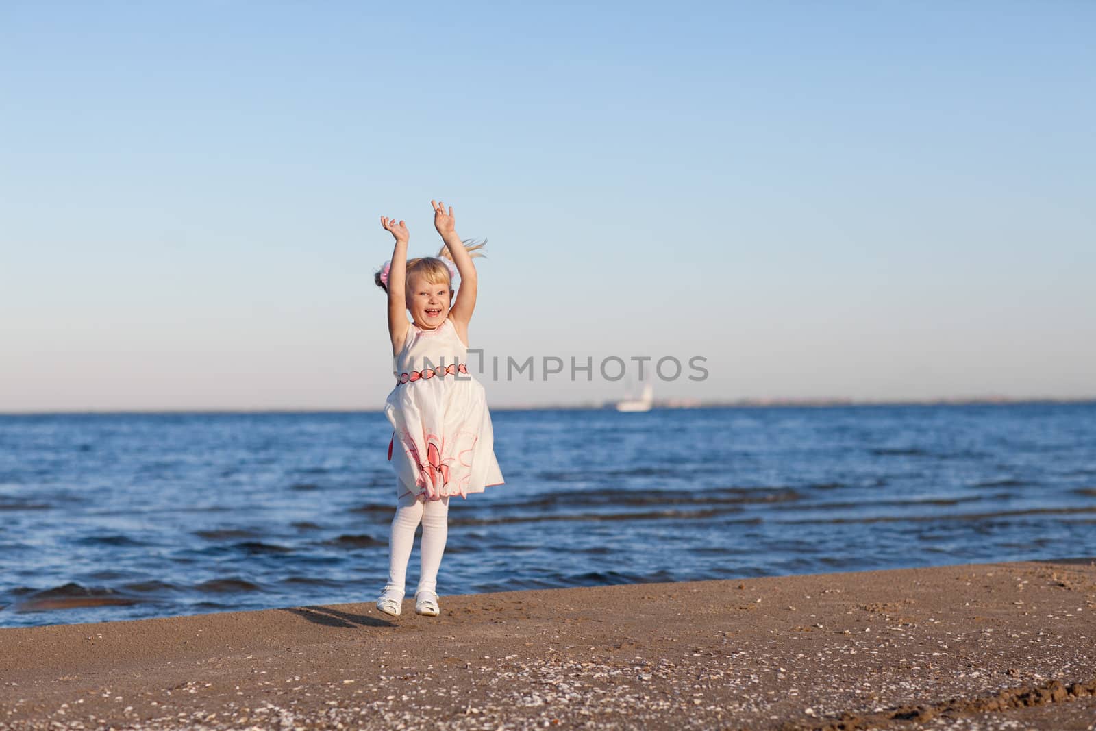 small jumping girl on the beach