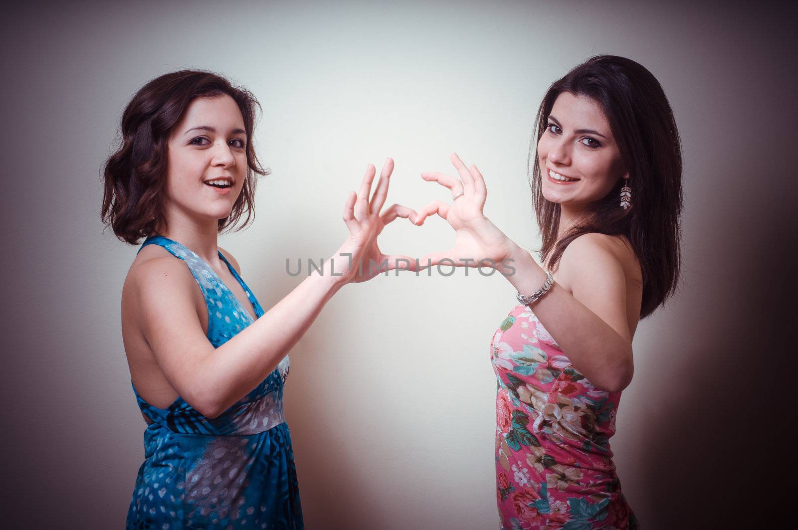 two beautiful girls on gray background