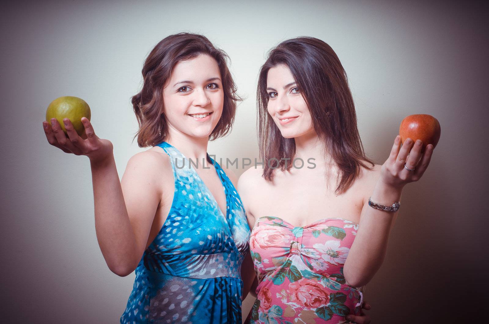 two beautiful girls on gray background