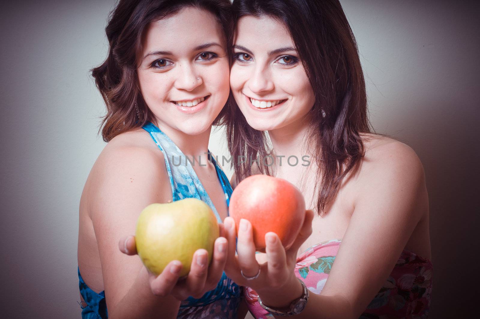 two beautiful girls on gray background