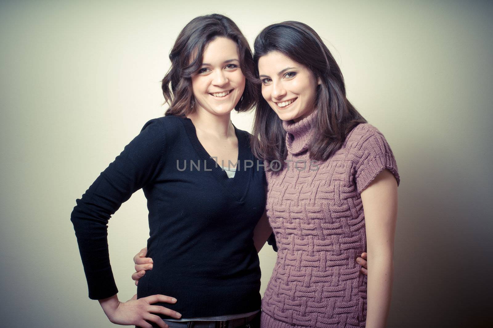 two beautiful girls on gray background