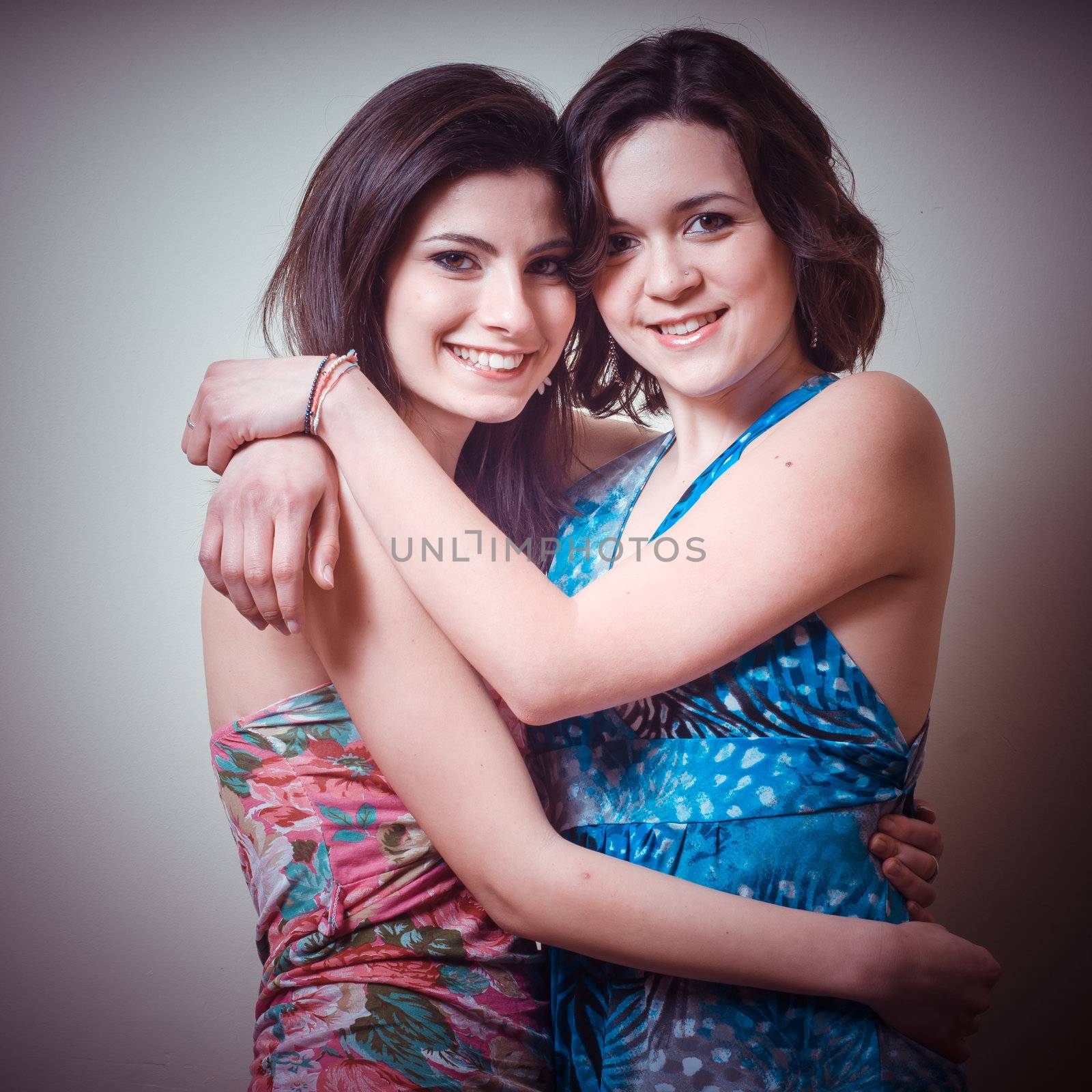 two beautiful girls on gray background