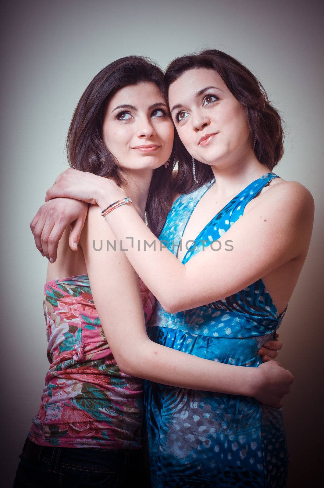 two beautiful girls on gray background