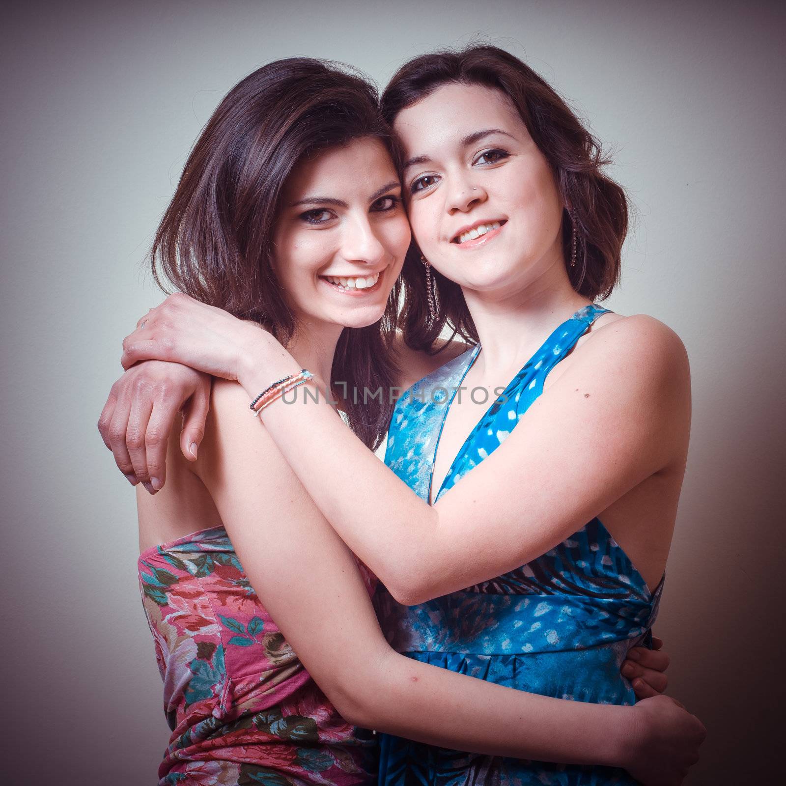 two beautiful girls on gray background