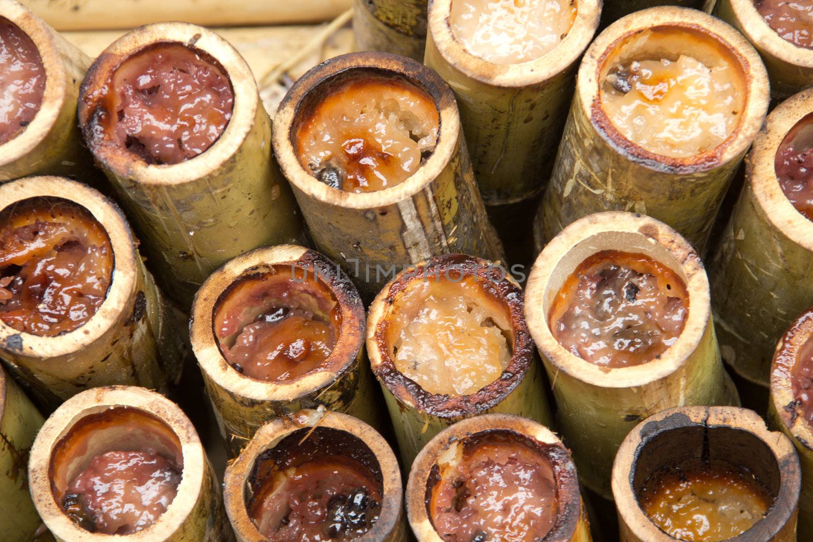 Glutinous rice roasted in bamboo joints., sticky rice in bamboo tube