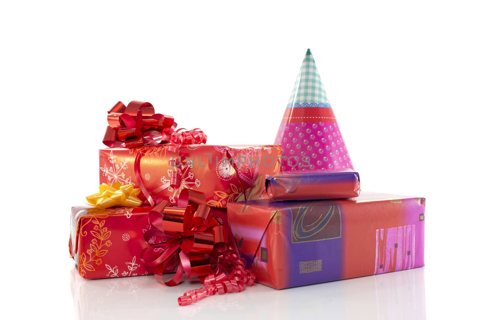 red and pink presents with party hat isolated on white