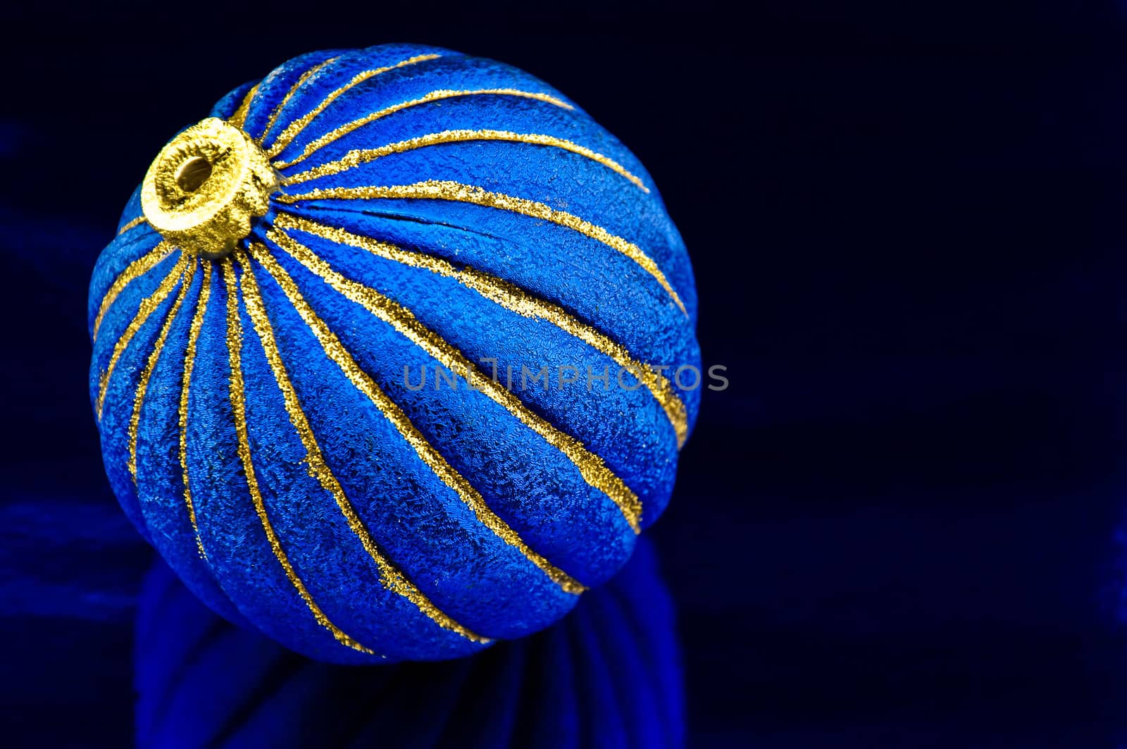 Bright  blue sphere for a christmas tree on a blue background