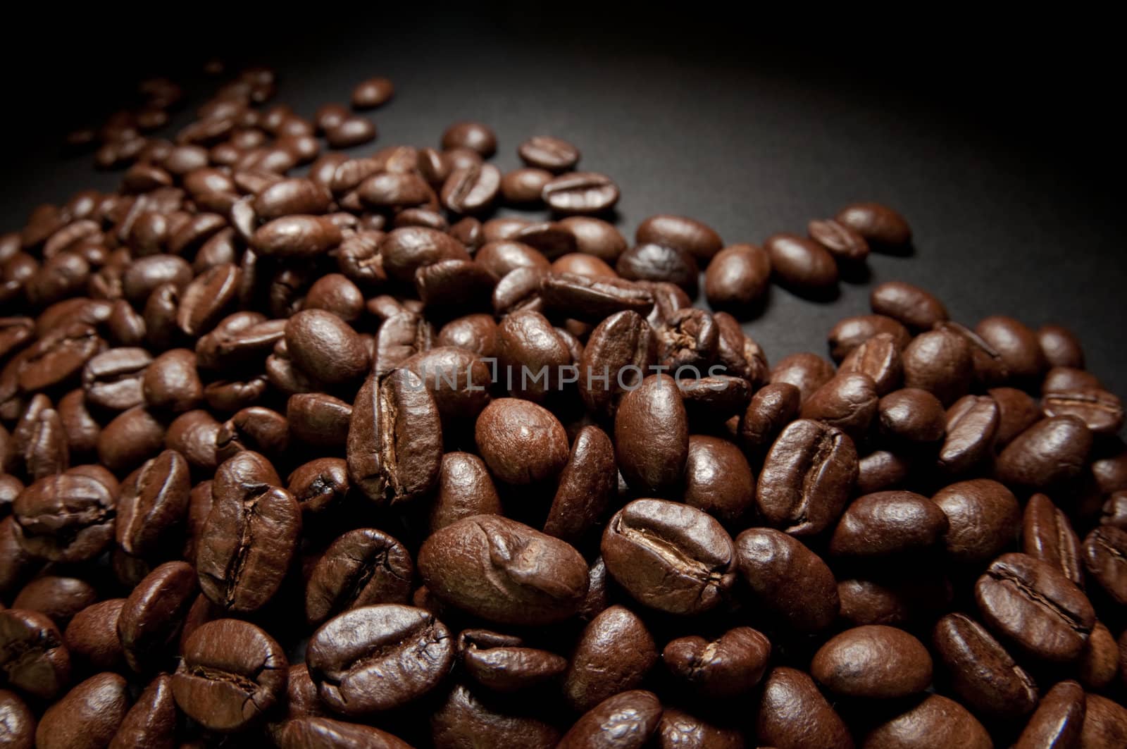 Coffee beans n a black studio background.
Selective focus. 