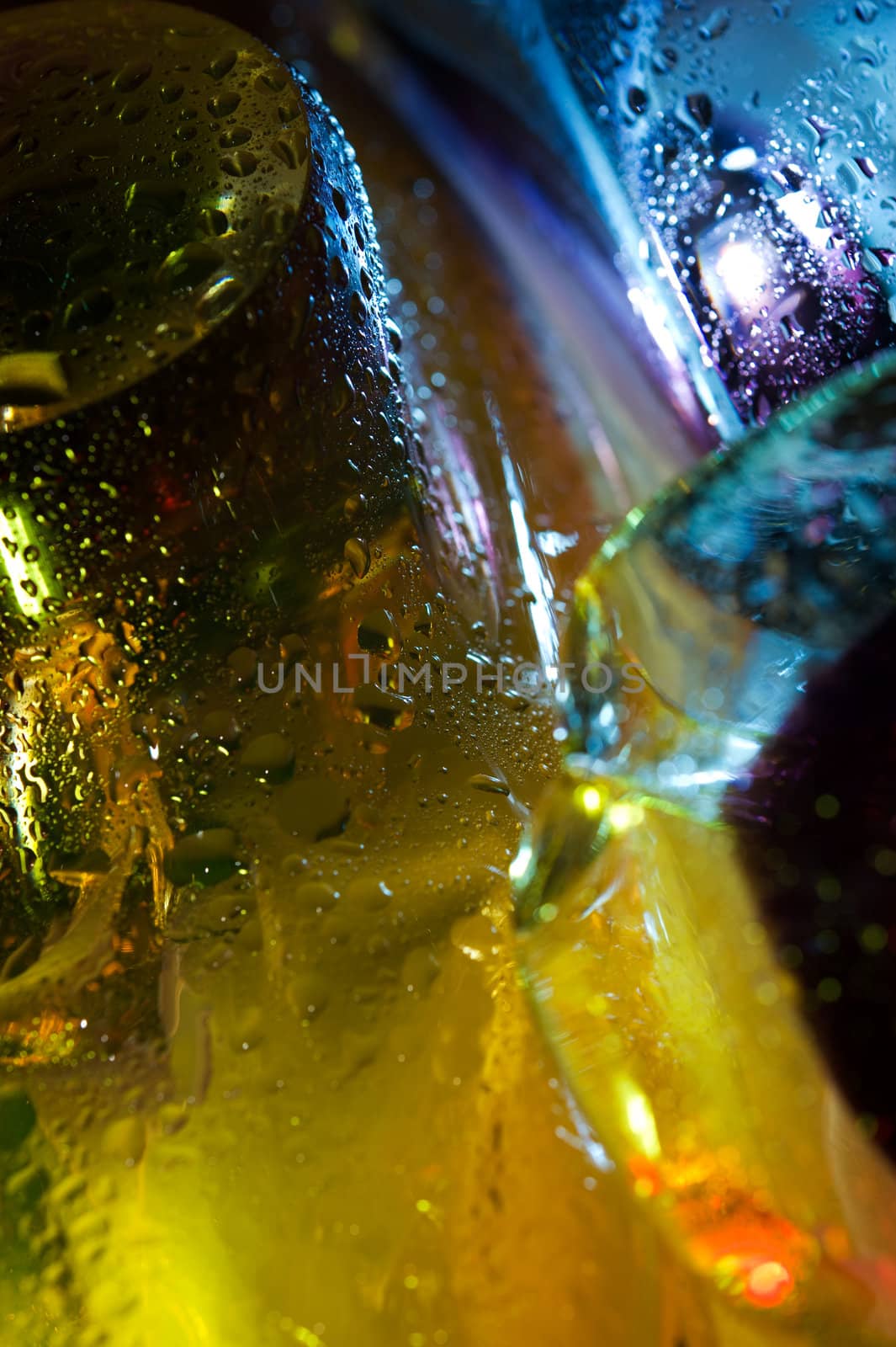 Bright colorful abstract background. Glass and drops of water. Closeup.