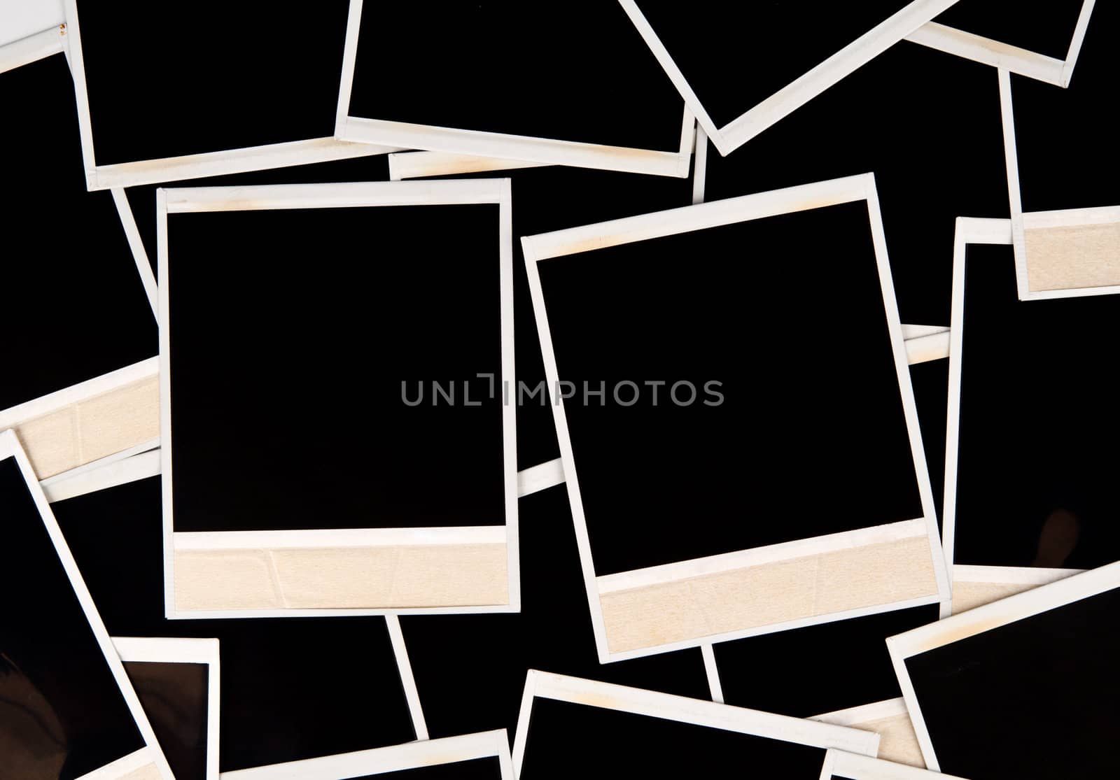Image of a random assortment/layout of a handful of empty instant prints. 