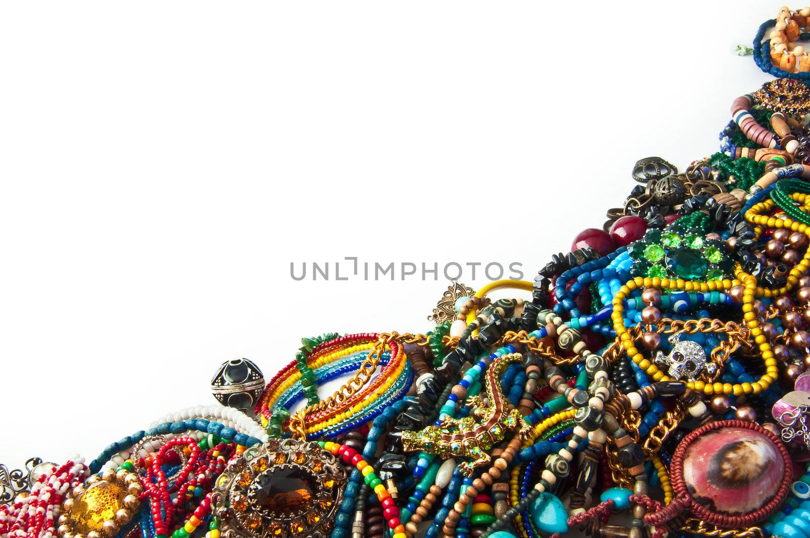 heap of multi-coloured bright jewelry isolated on a white background