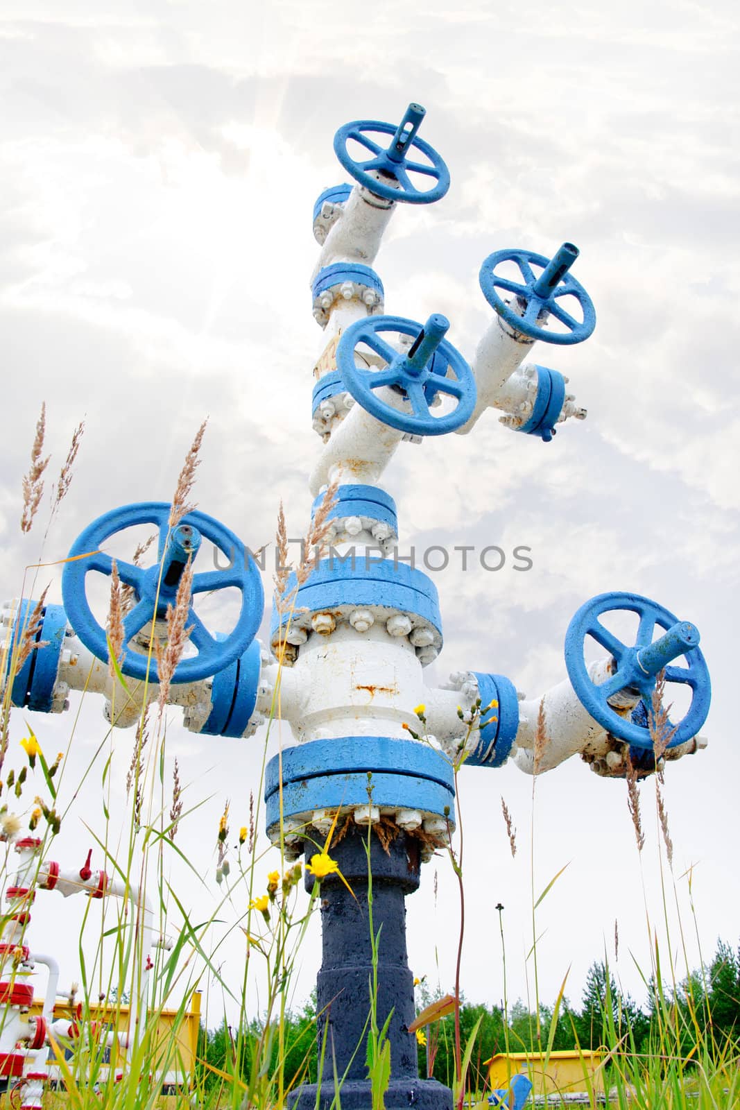 Oil, gas industry. Wellhead with valve armature on a sky background.