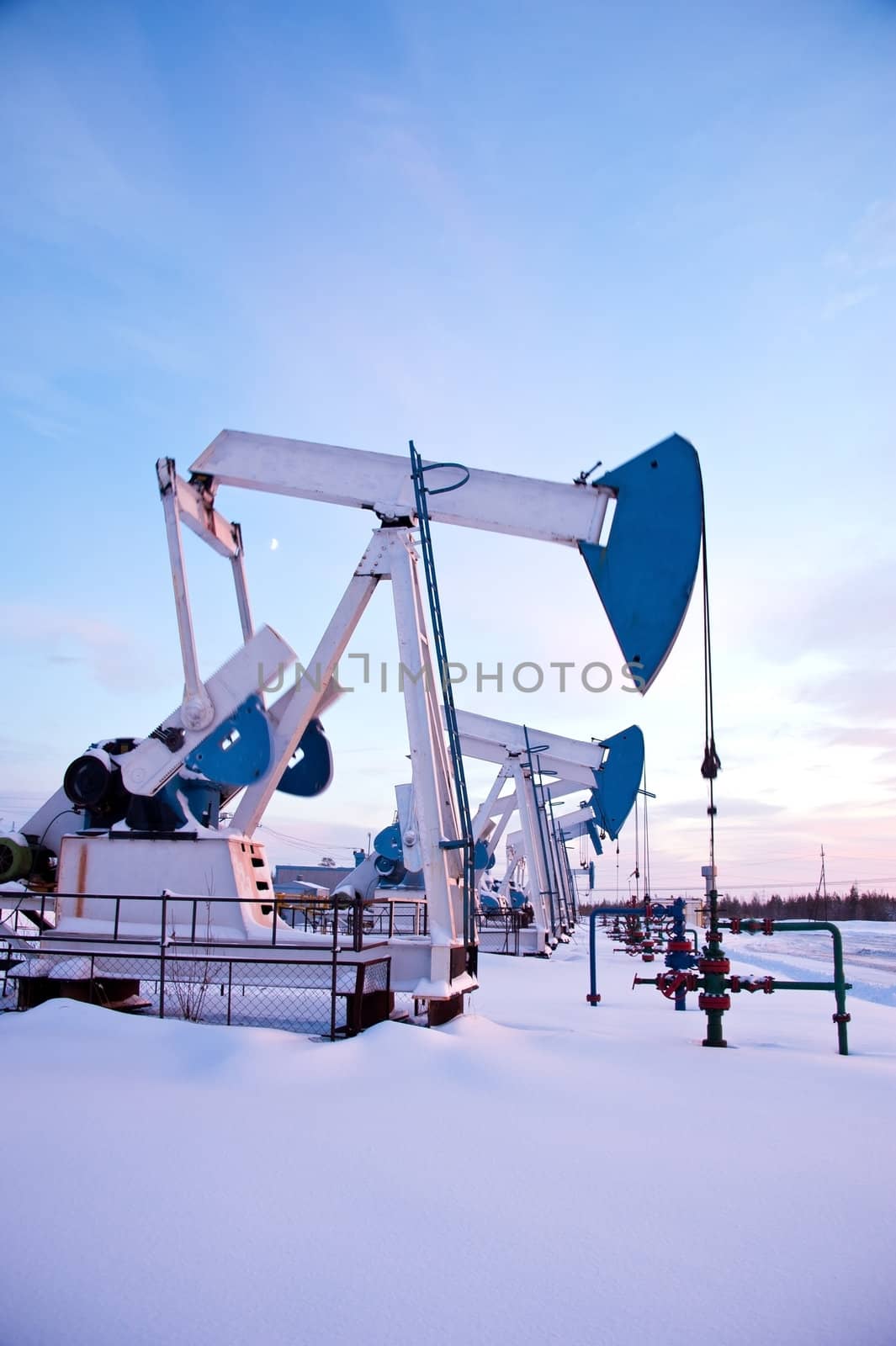 oil pumps on the sunset sky background