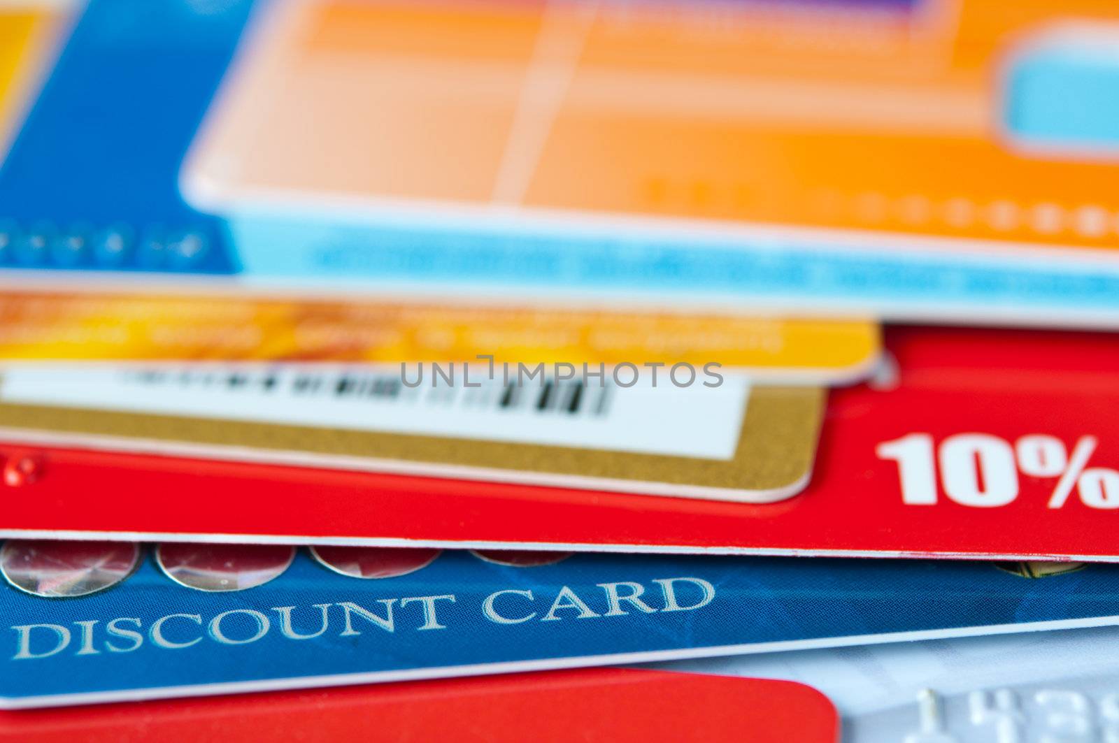 bright plastic discount cards closeup. market  background. selective focus.