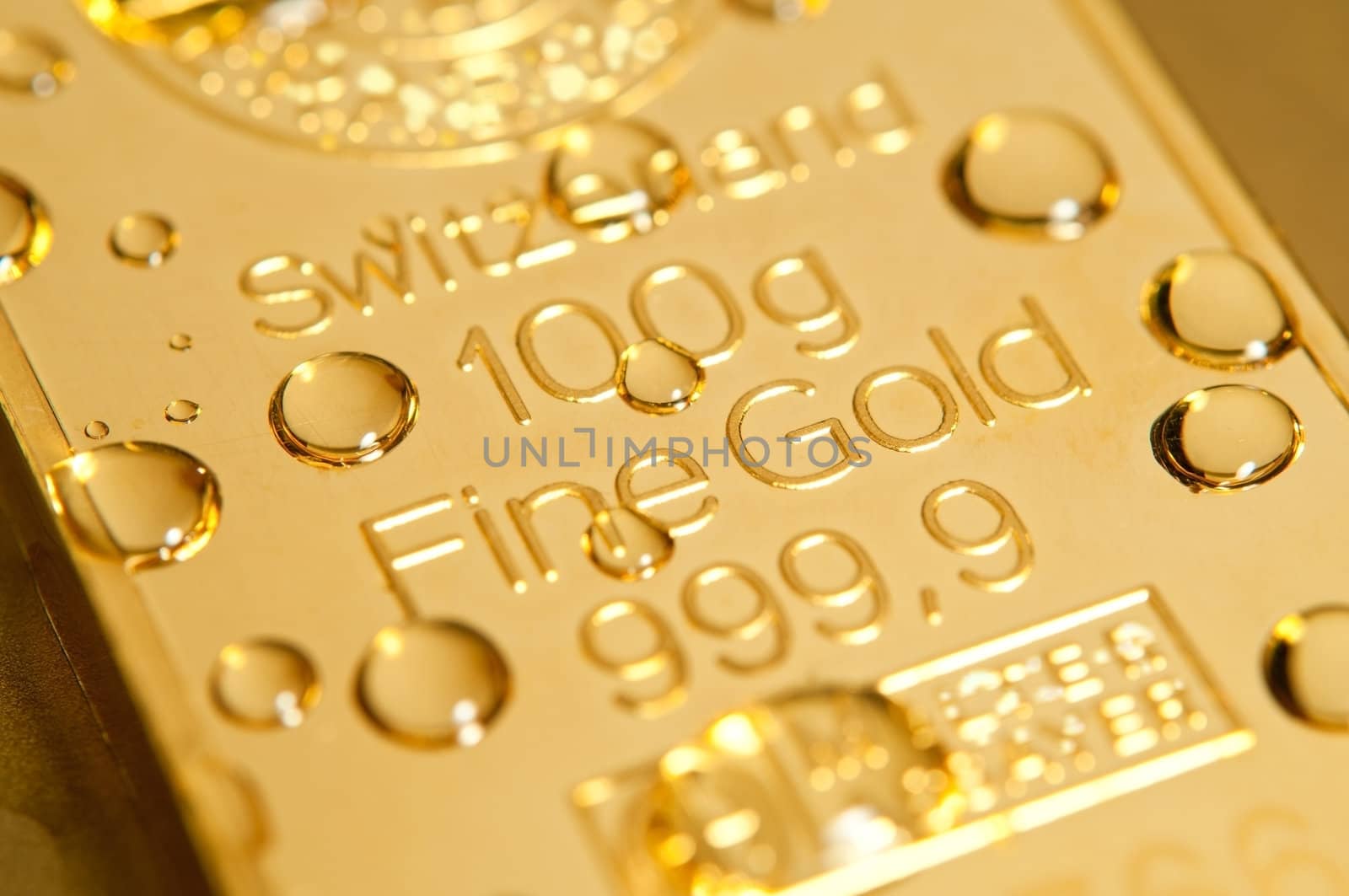 gold ingot and water drops background. closeup.