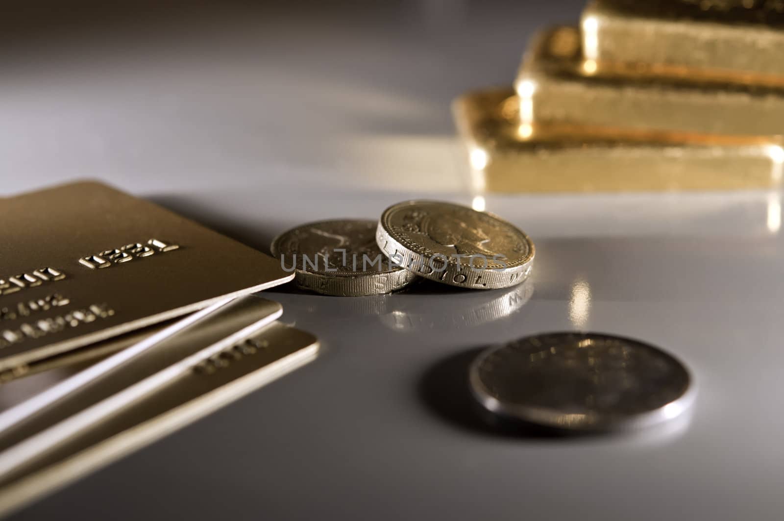 golden credit card, coins and gold ingot. (The depth of the field is low.)