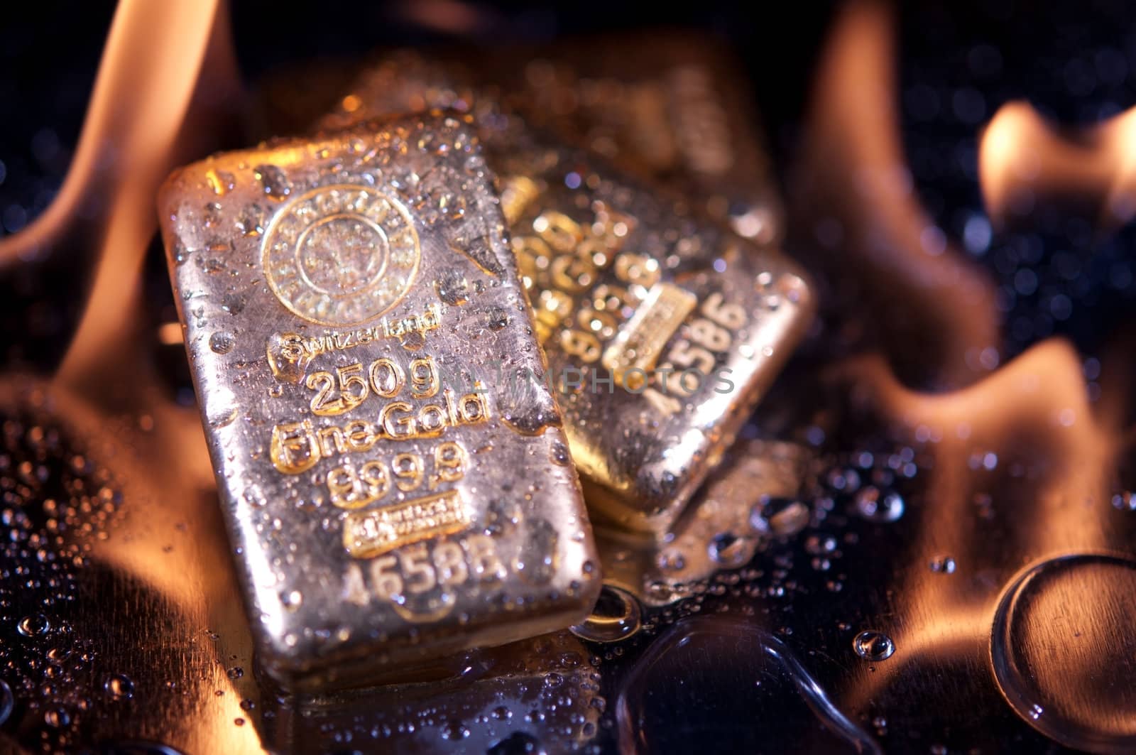 gold bullion and  flame. safe investments.