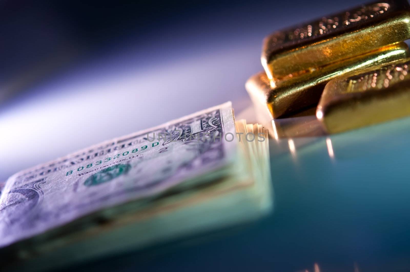 stack of banknotes and gold bars on blue and purple background