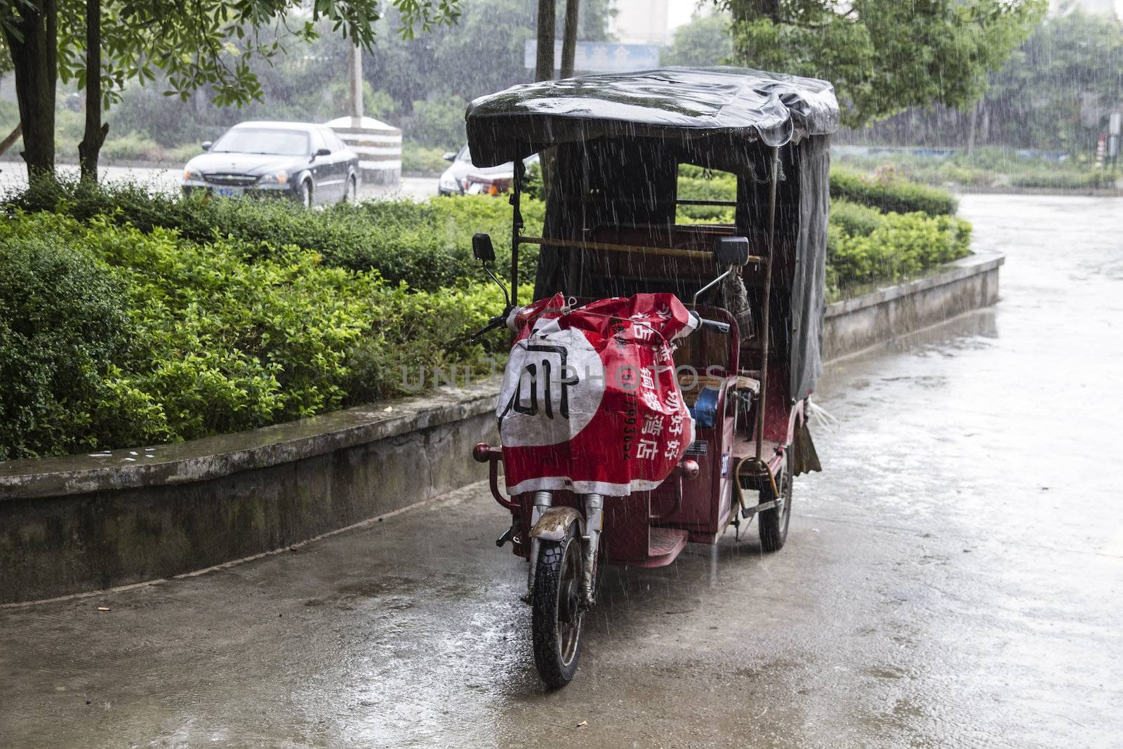 Electric pedicab taxi in the rain