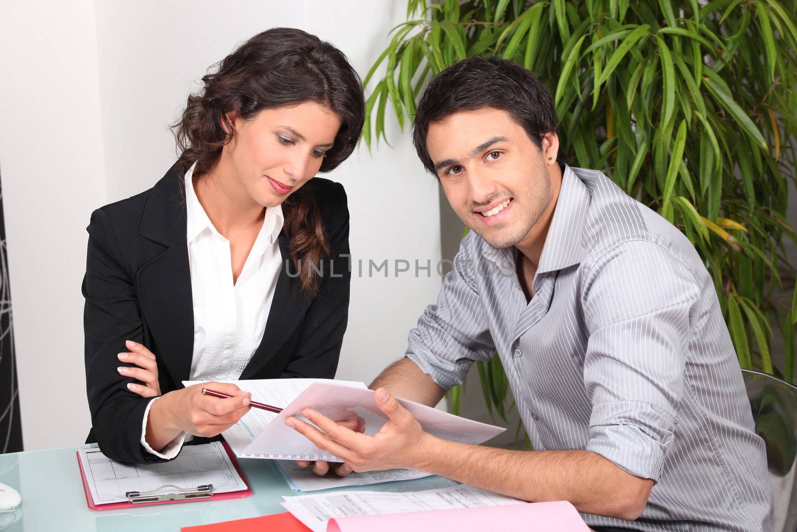 Agent and client discussing a document