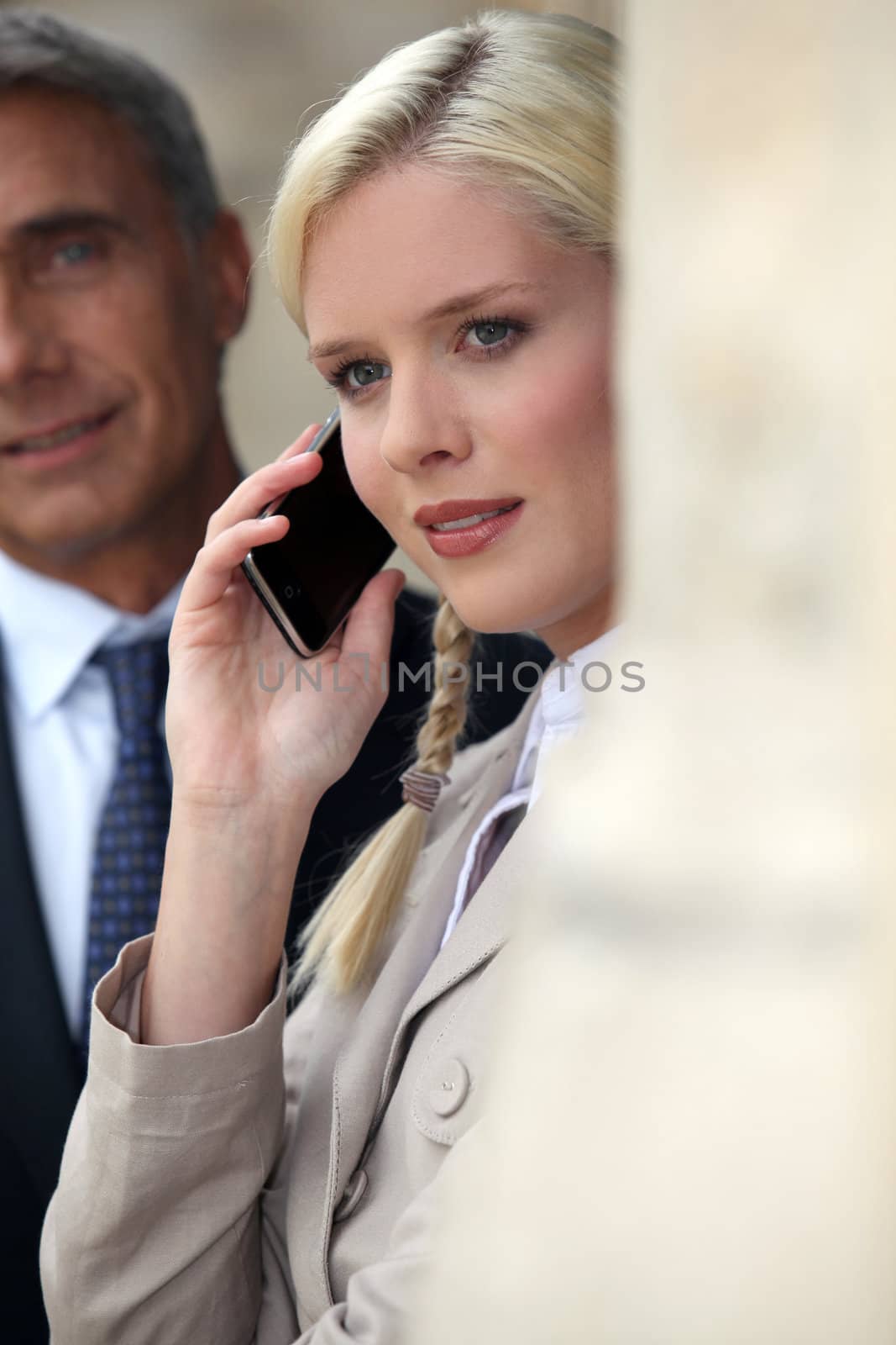 Young woman pensive on phone by phovoir