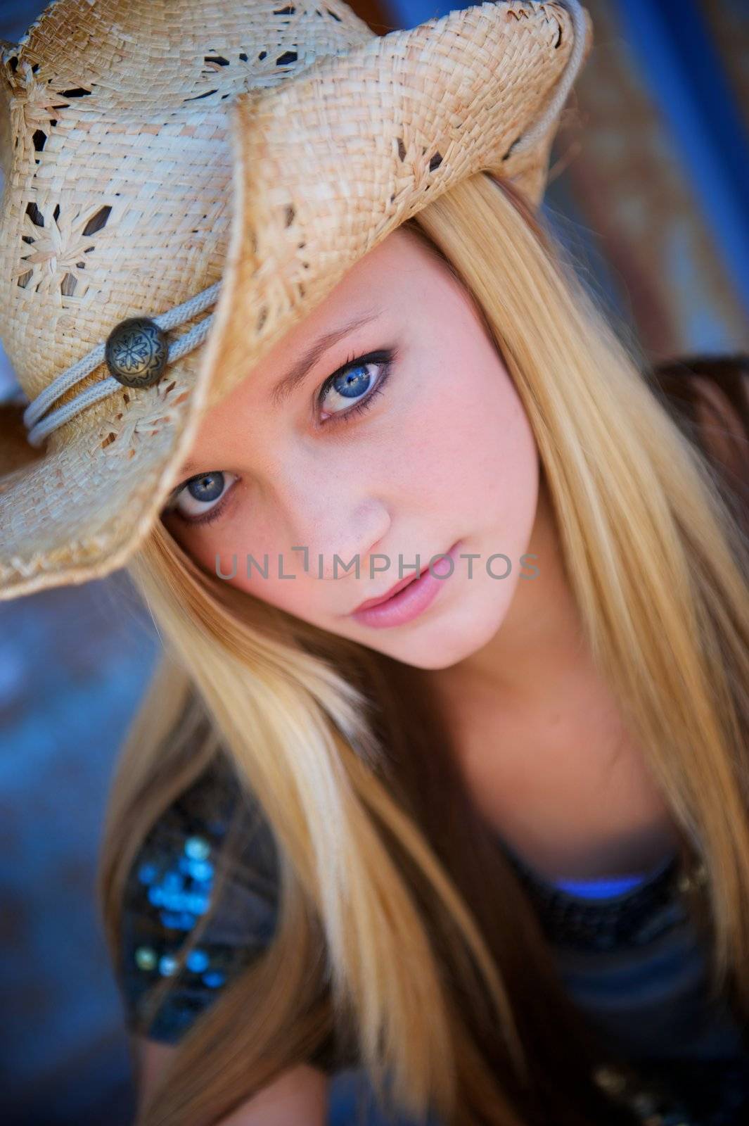 Attractive Blond Model Peers Out From Under Her Tattered Cowboy Hat