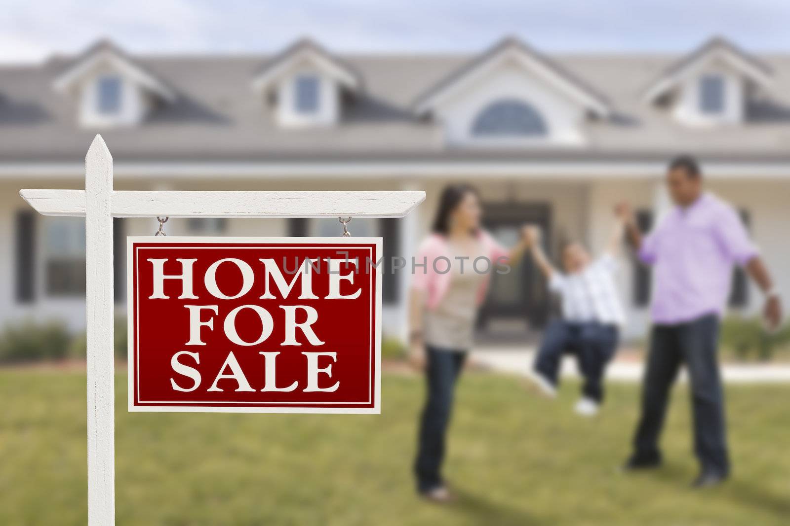 Home For Sale Real Estate Sign and Playful Hispanic Family in Front of House.