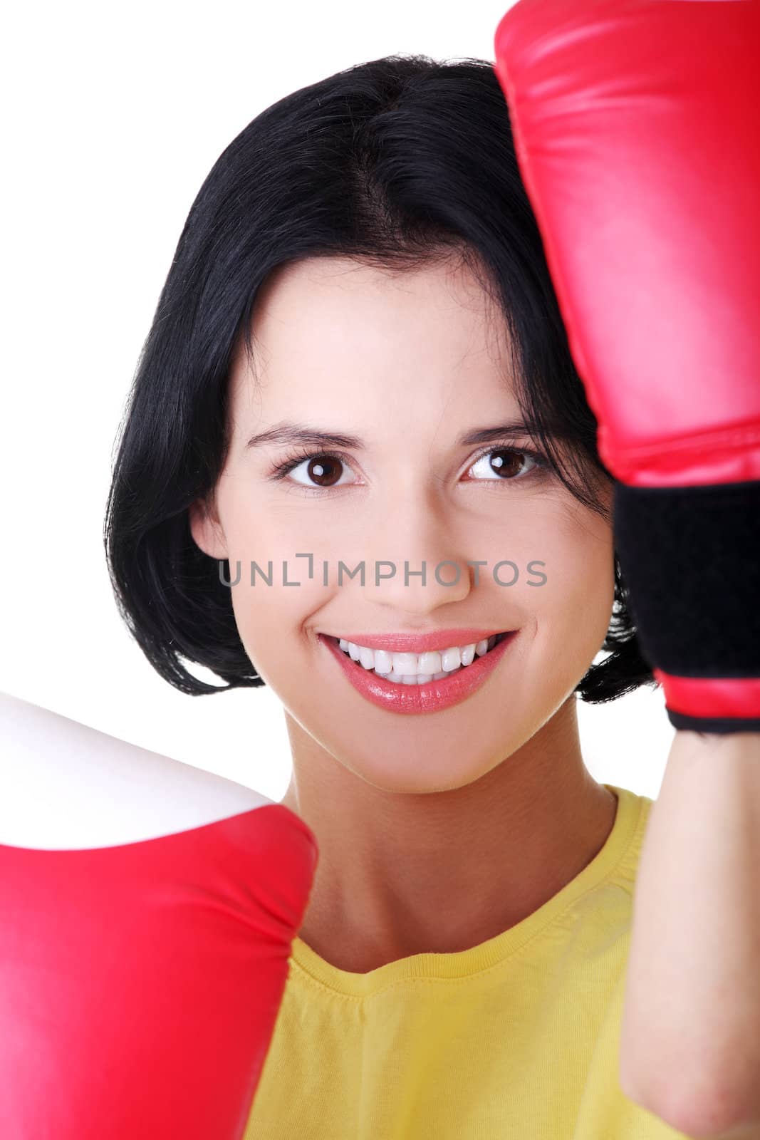 Young woman wearing a pair of boxing gloves. by BDS