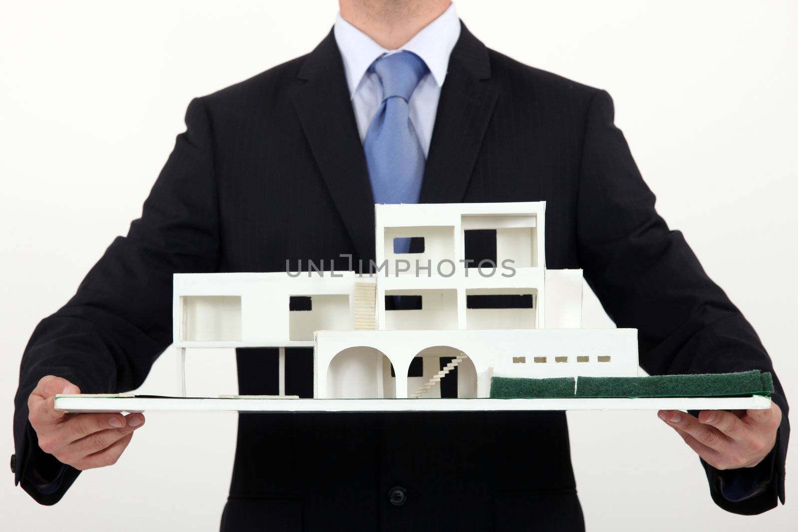 Architect holding scale replica of building by phovoir