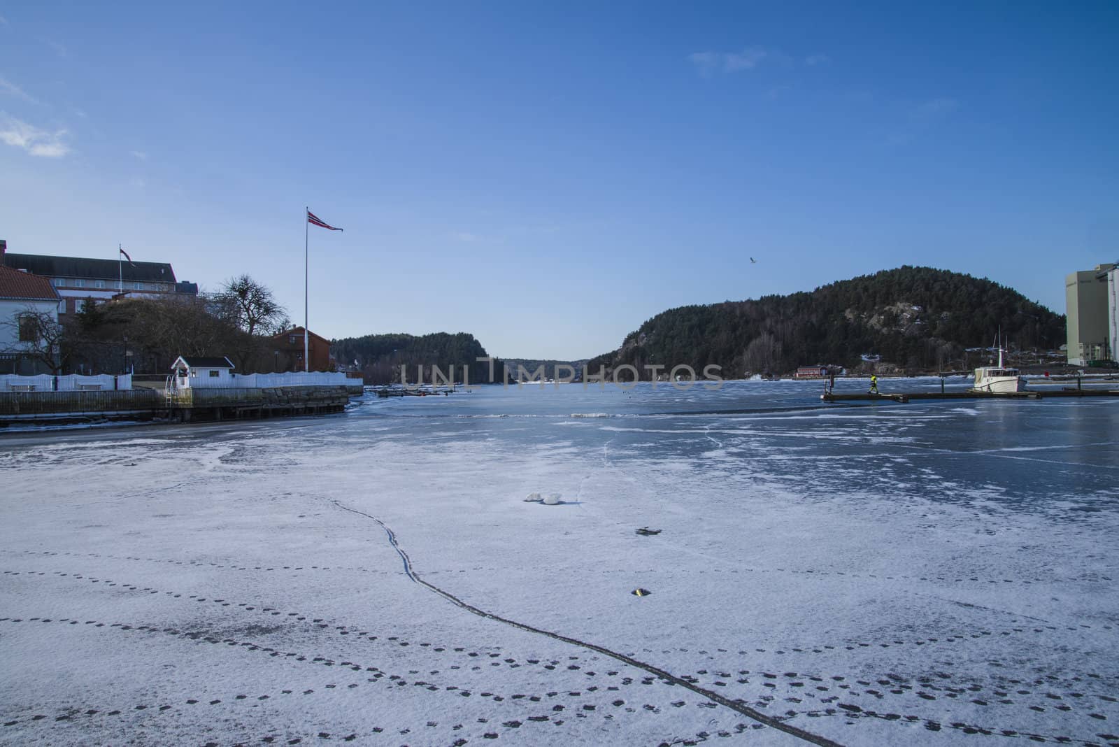 It's been a cold winter and the harbor of Halden, Norway is frozen into ice. The picture was shot one day in March 2013