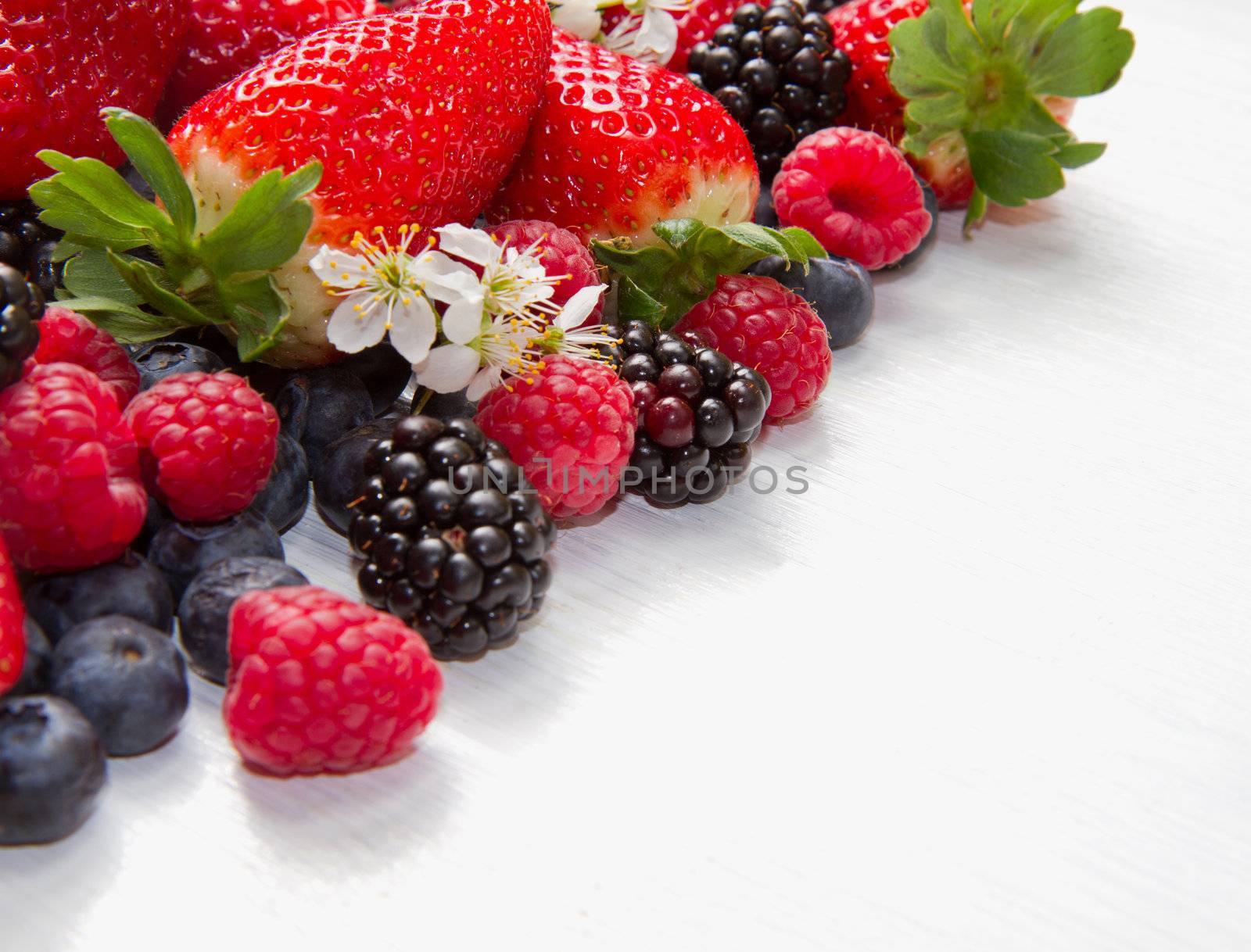Berry over white  Wood. Strawberries, Raspberries, Blueberry