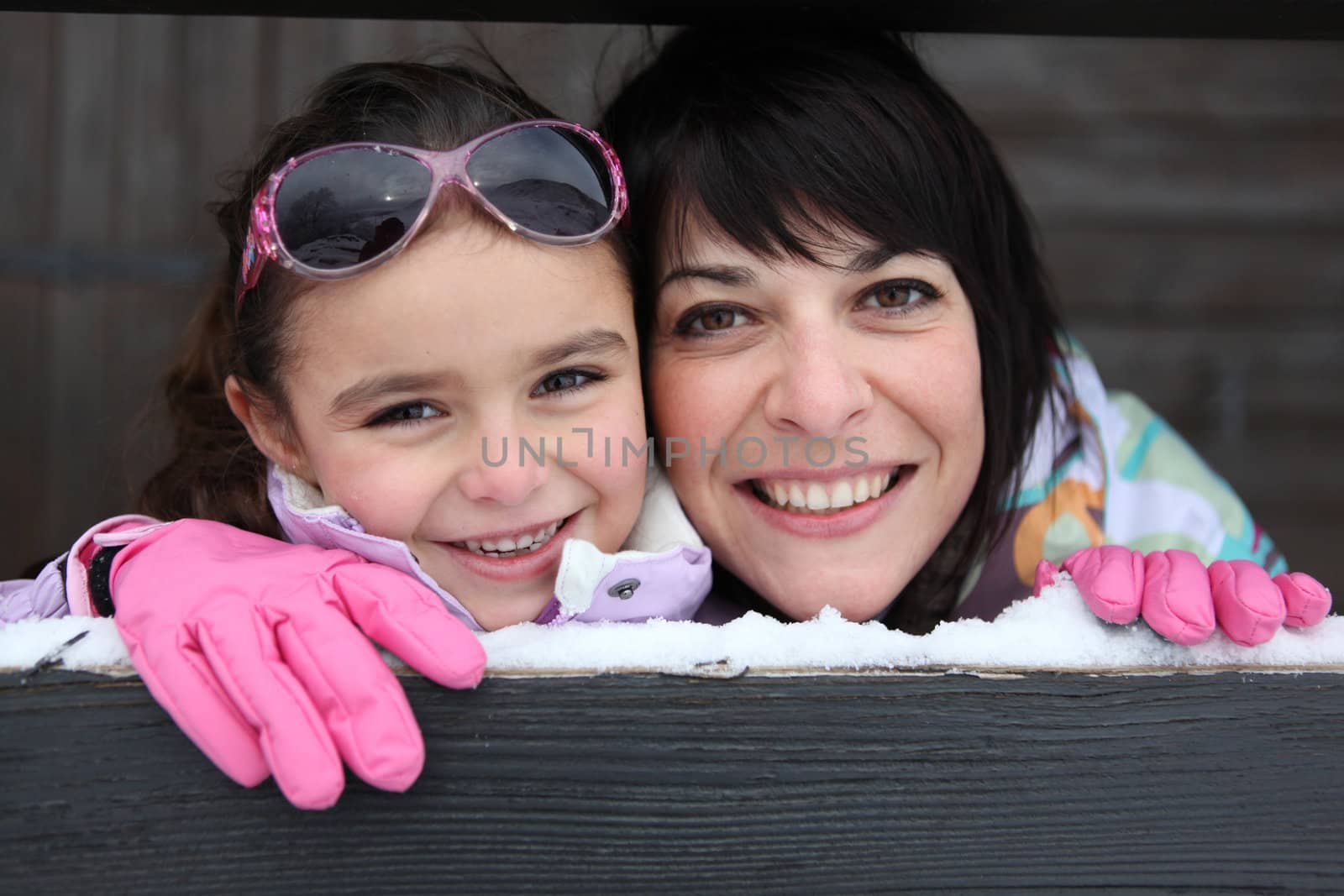 Mother and daughter stood by their ski house by phovoir