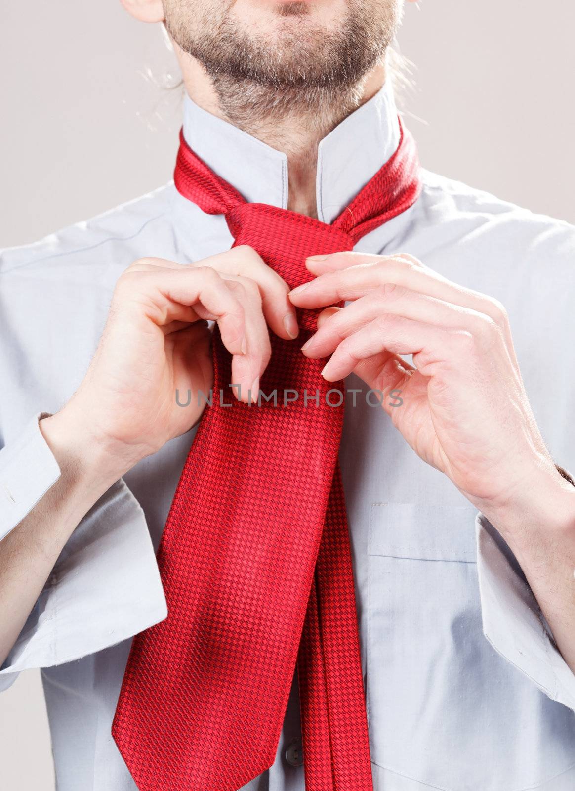 Man adjusting tie 