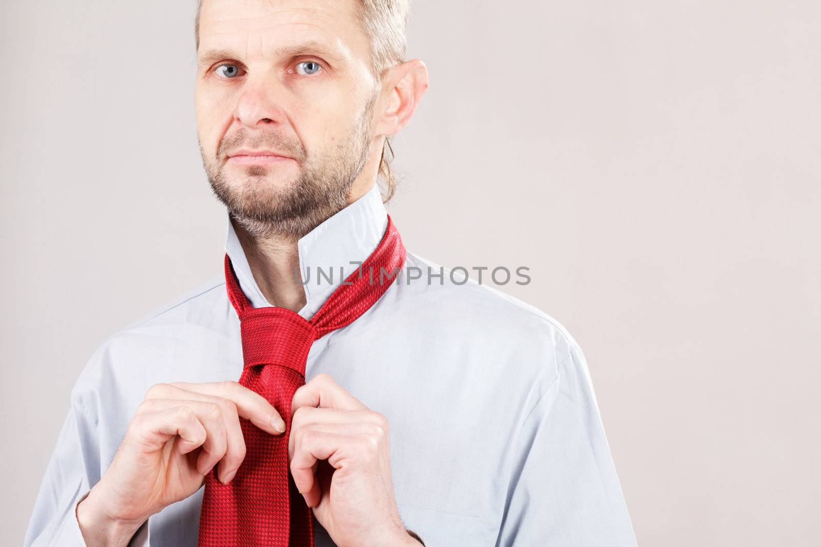 Man adjusting tie 
