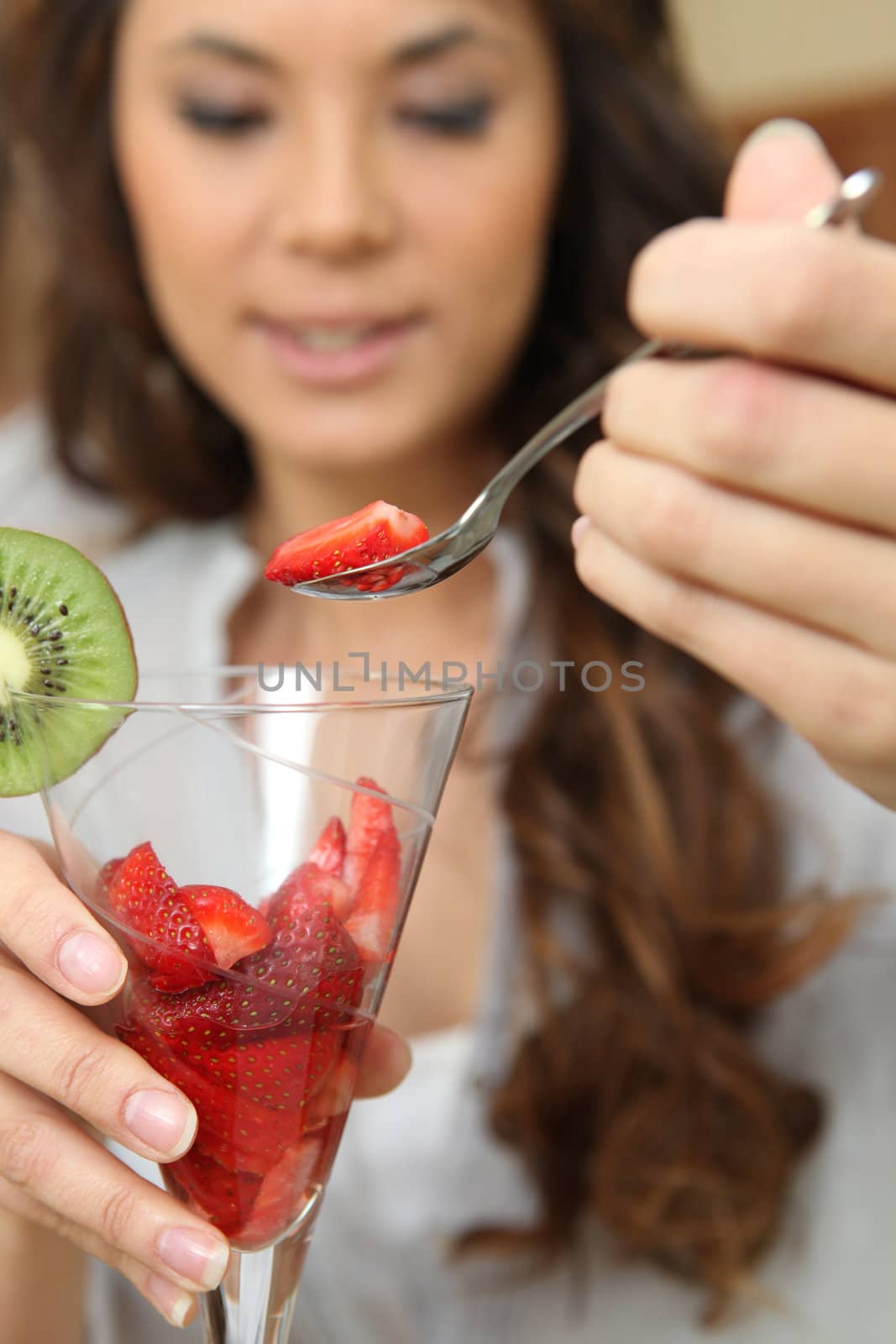 Woman eating strawberries