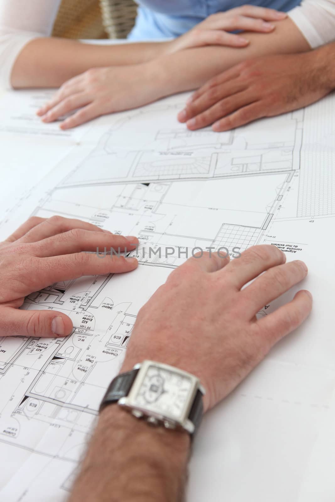 Close-up of architects examining floor-plans Narbonne_Neil_160410;Dubbroca_Joffrey_160410;Mounier_Karen_160410