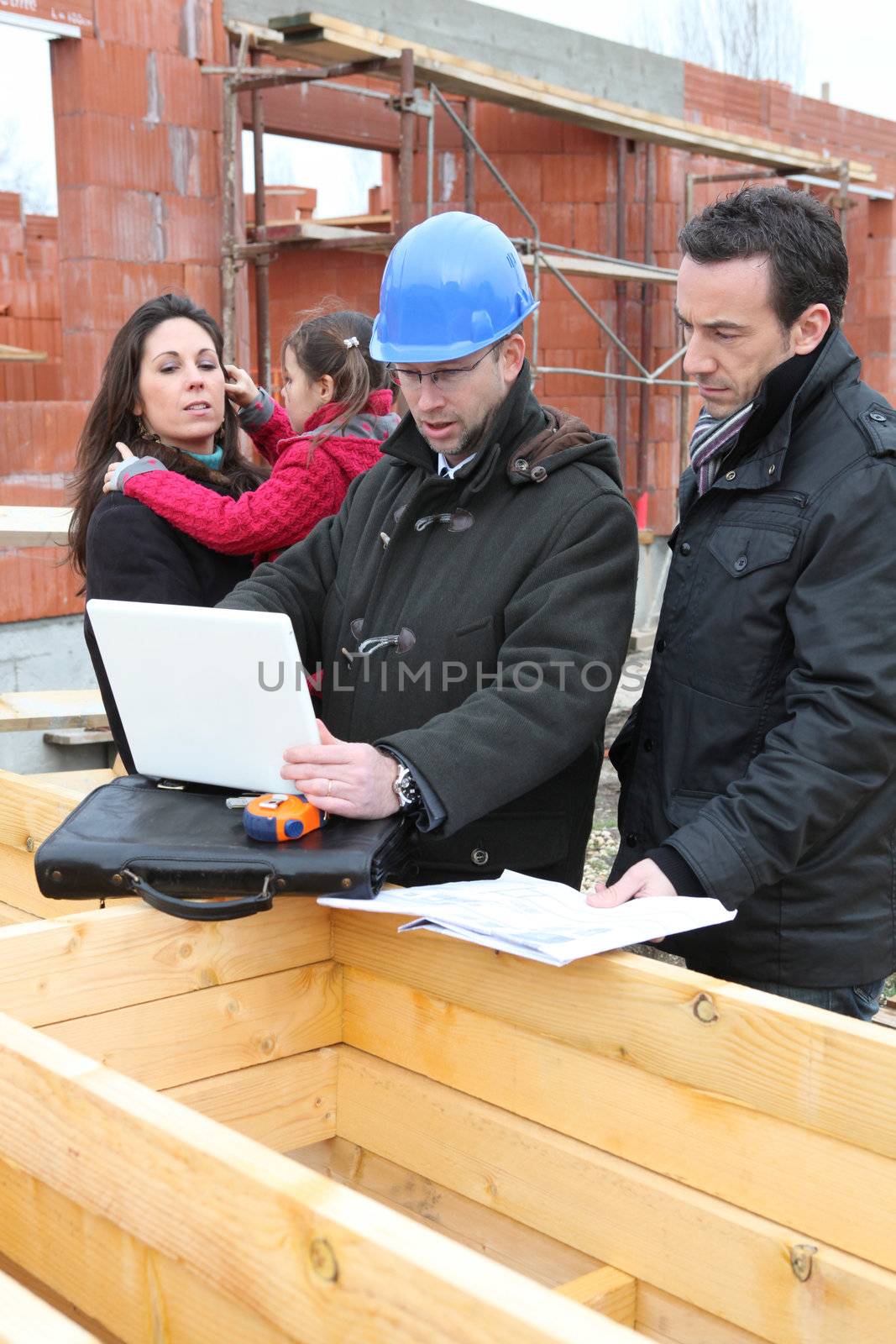 Family inspecting there unfinished future home