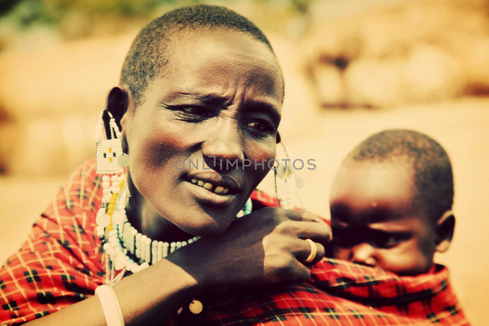 Maasai village, TANZANIA, AFRICA - DECEMBER 11: A two year old Maasai of an unidentified name crying when carried by his mother going for water on December 11, 2012 in Ngorongoro Tanzania.