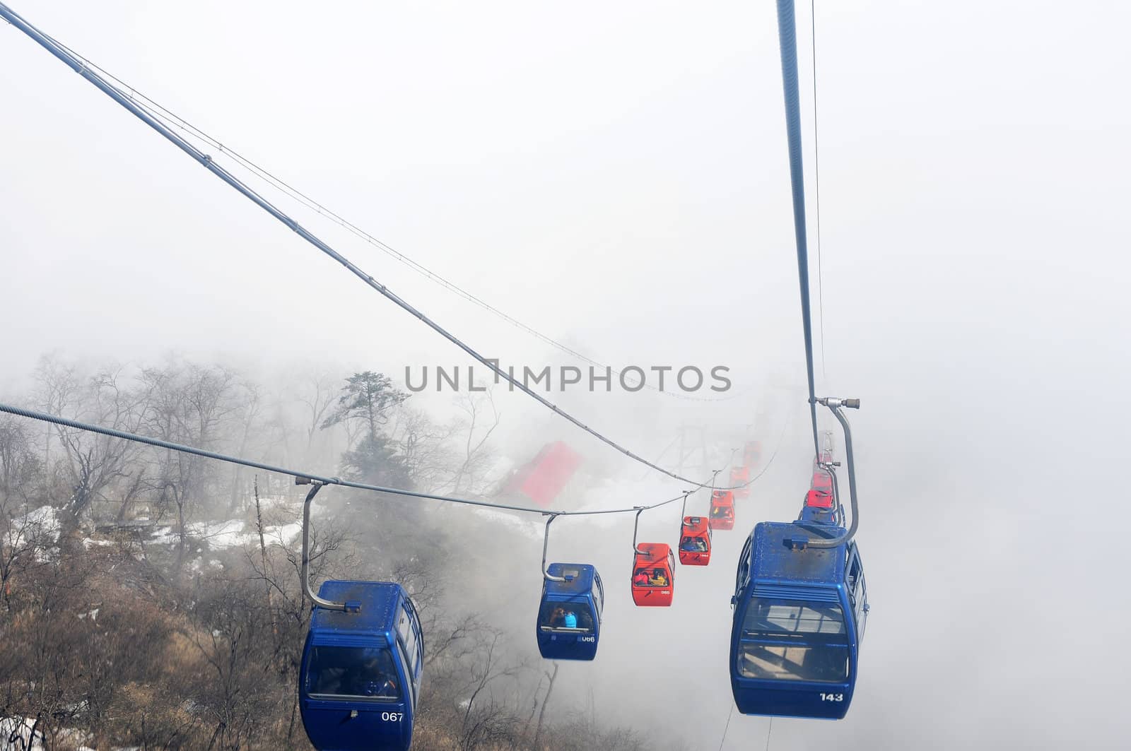 Cable cars in a foggy and cloudy day
