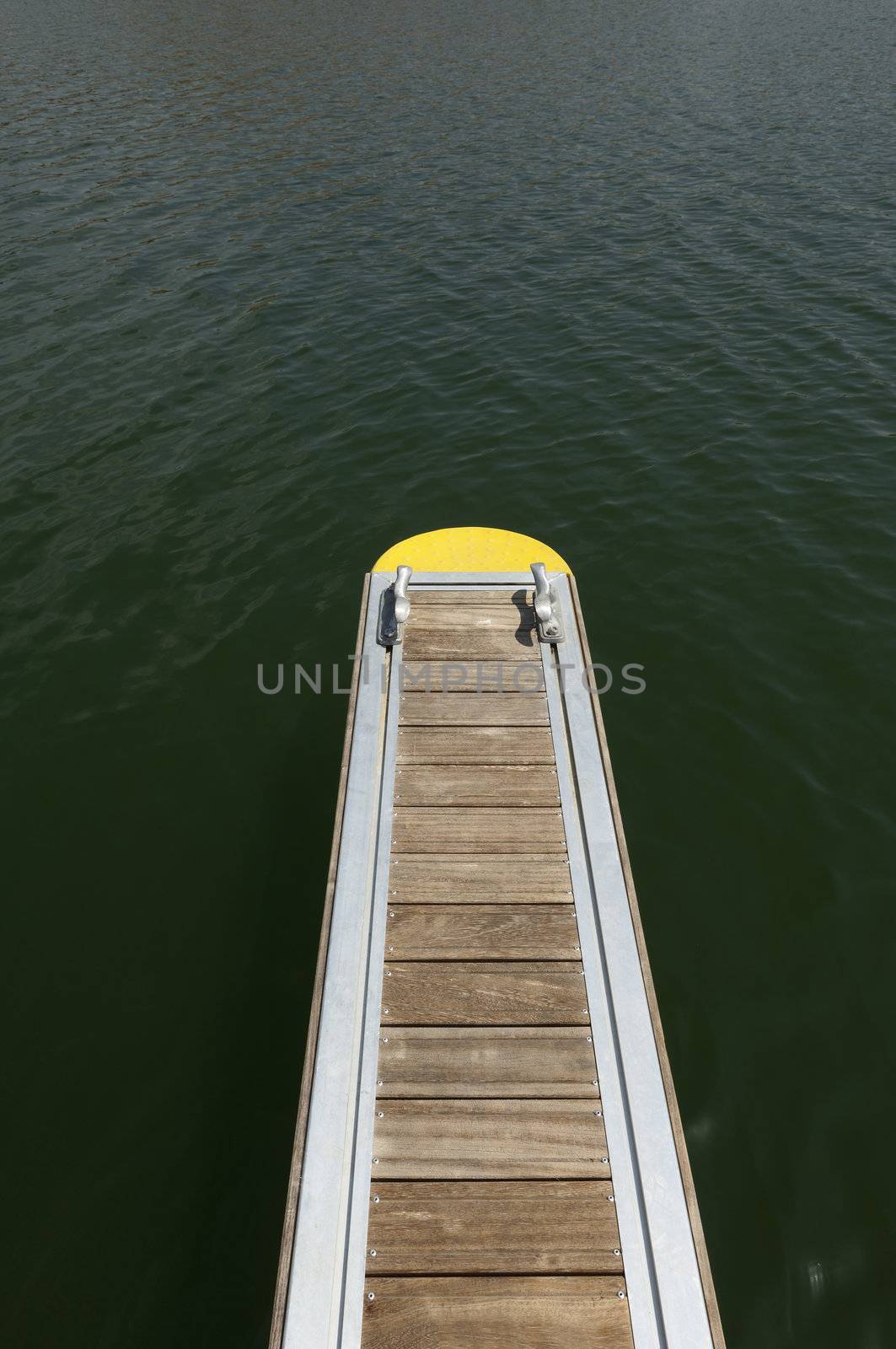 Detail of a wooden floating dock with mooring bitts