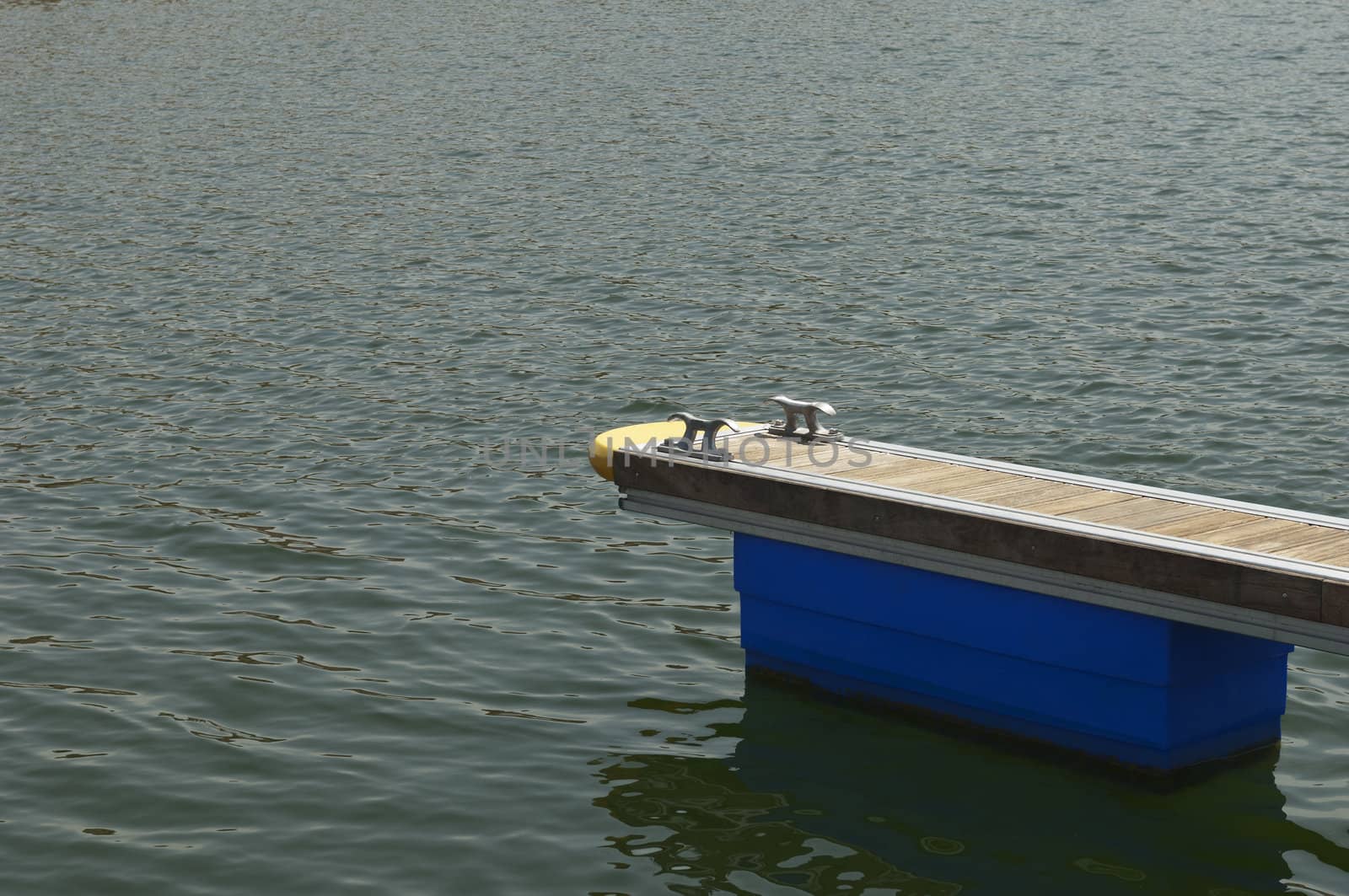 Detail of a wooden floating dock with mooring bitts