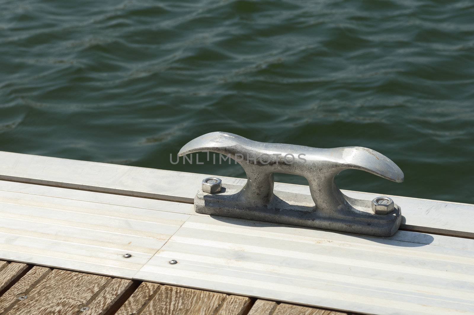 Detail of a wooden floating dock with mooring bitts