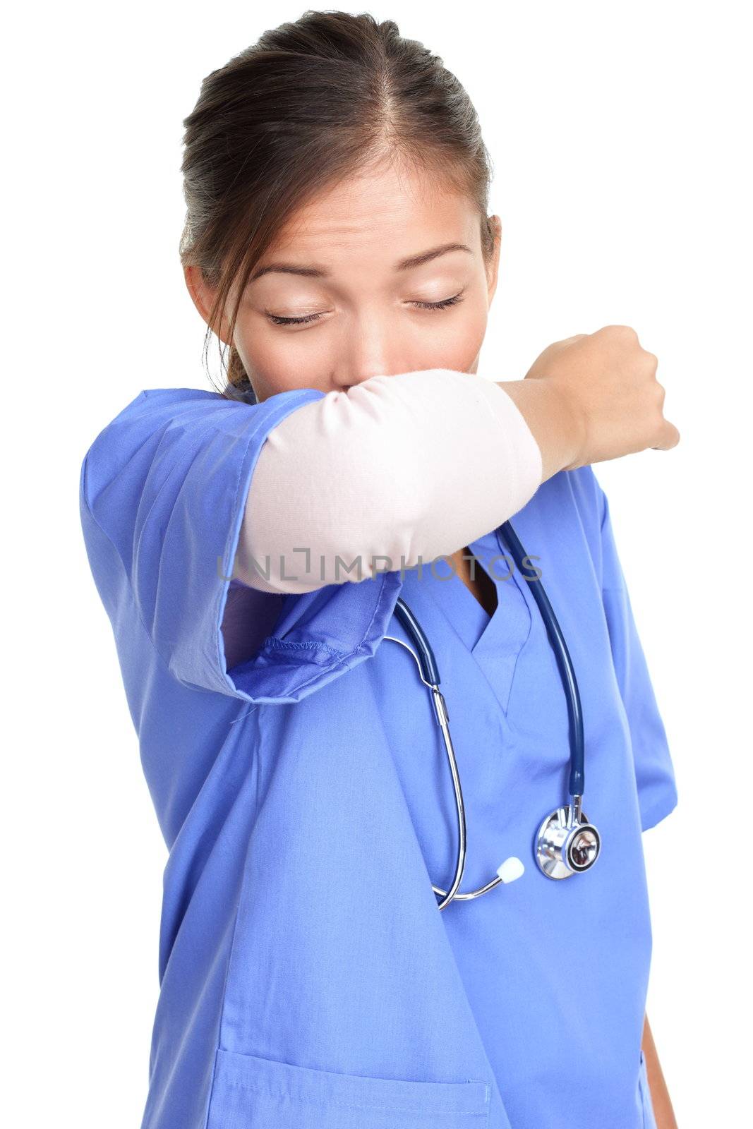 Sneezing woman medical nurse or doctor doing elbow sneeze being sick having the cold flu. Sneezing instruction concept with person in medical scrubs. Young female isolated on white background