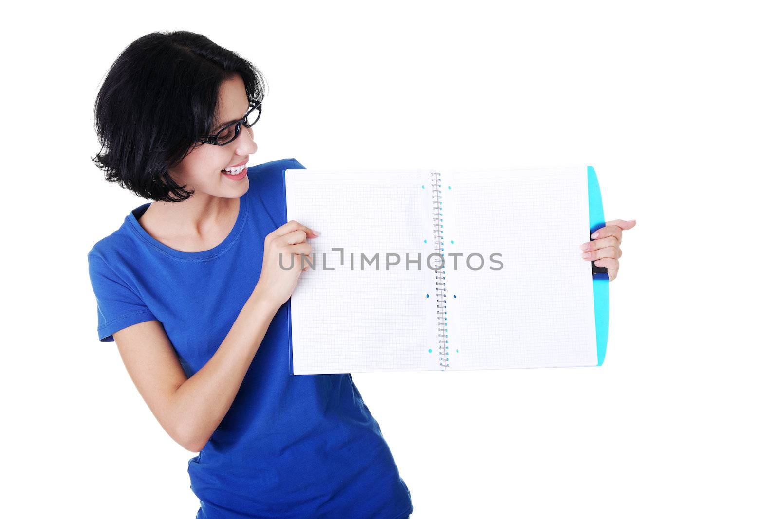 Studying happy young woman showing blank pages of her notebook for school.