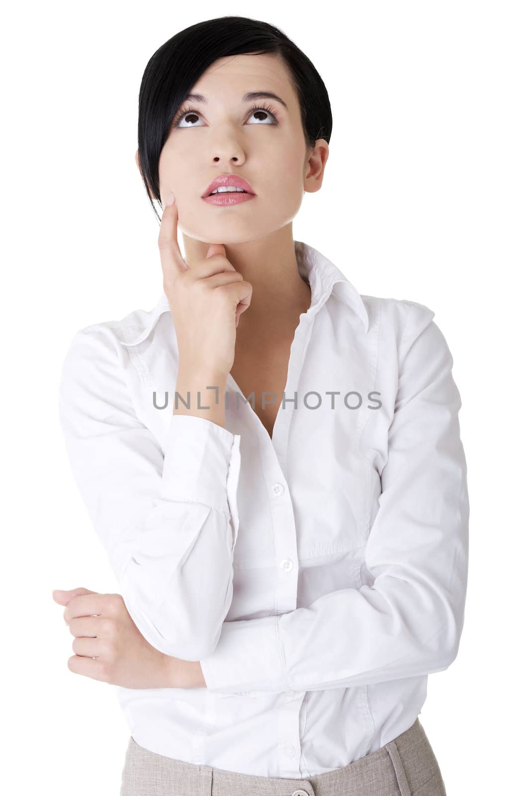 Young thoughtful businesswoman looking up