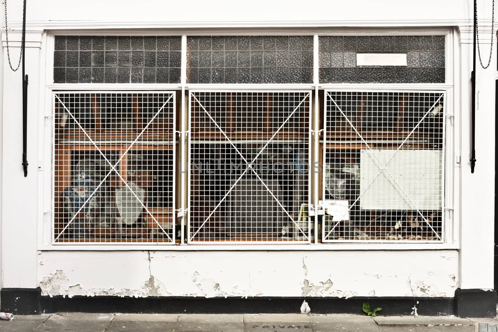 A store protected by window metal bars in a town