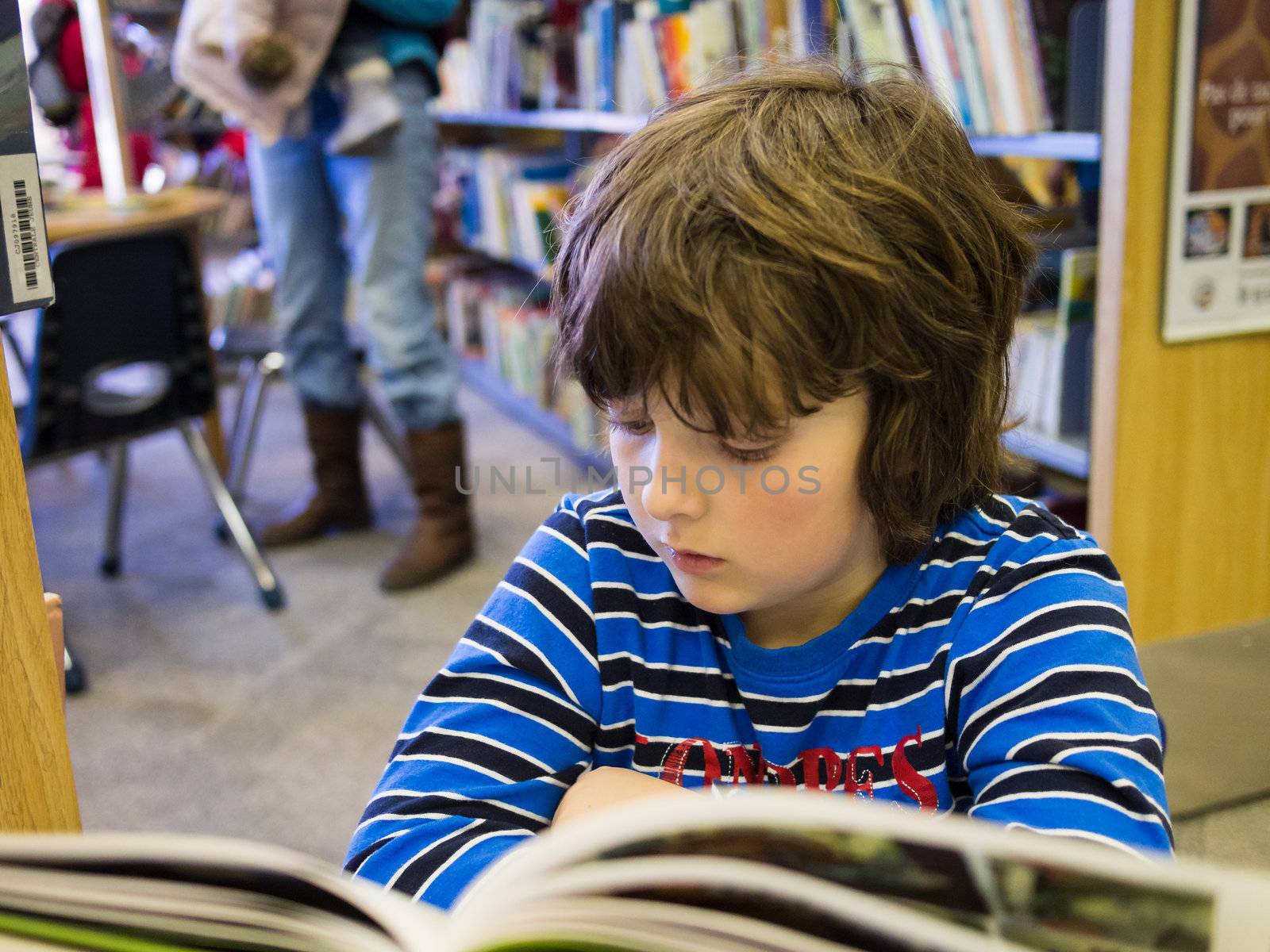 Boy reading a book by Talanis