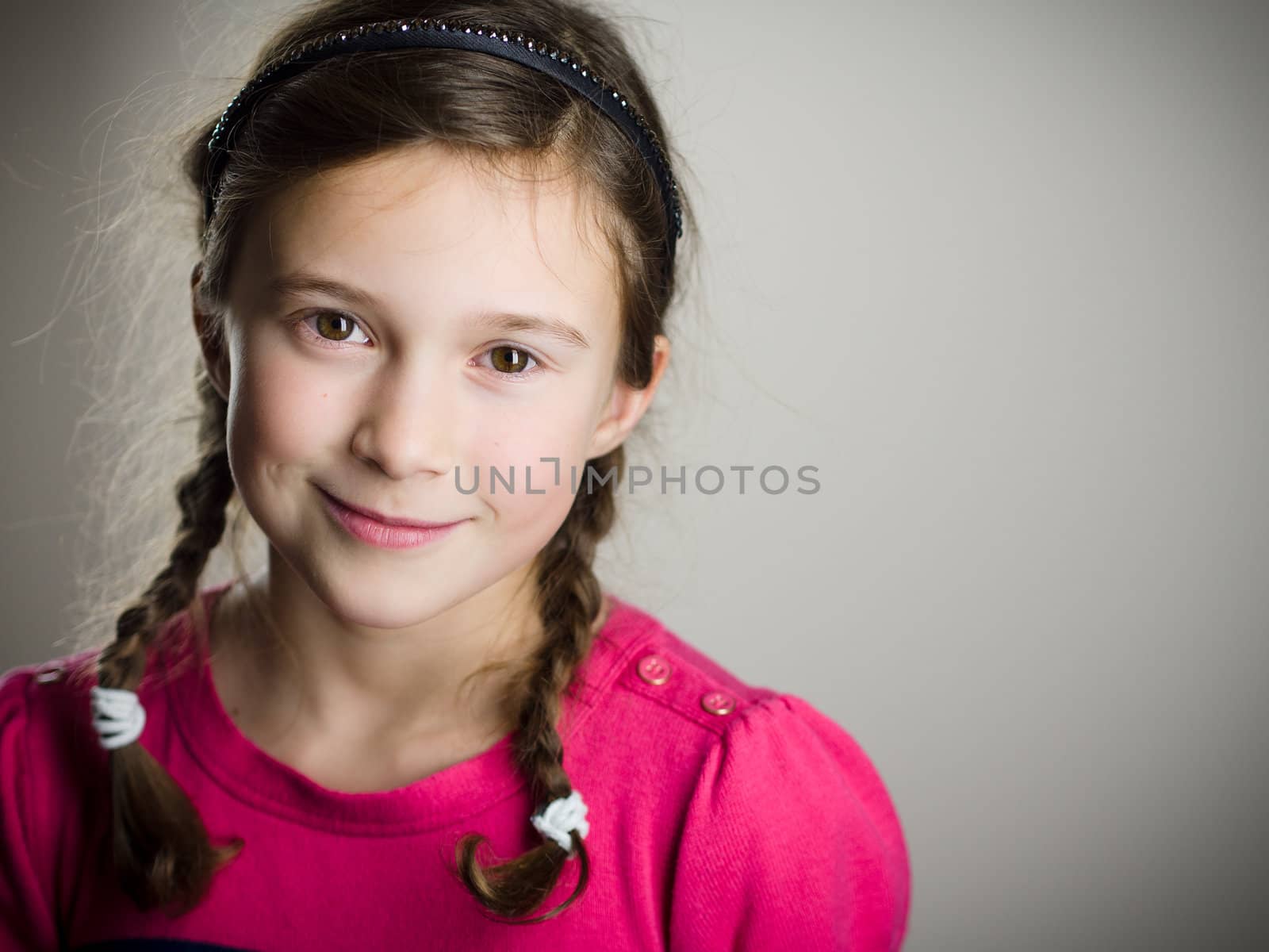 Cute little girl smiling in studio