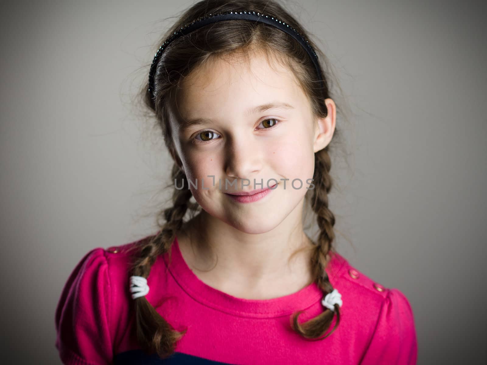 Cute little girl smiling in studio